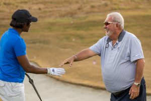 Danielle receiving golf instruction at a Tee It Up for the Troops REUNION Event.