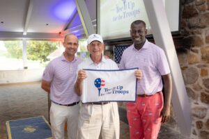 Johnny Carpineta, US Army veteran, displaying his hole-in-one flag with Springhaven Club leaders.